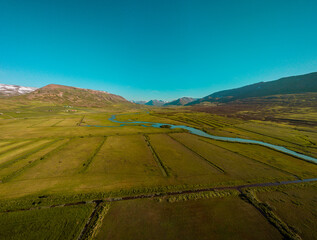 Beautiful valley of Miklavatn lake close to Haganes with aerial drone view of river delta and beautiful Icelandic hills and mountains in the background.