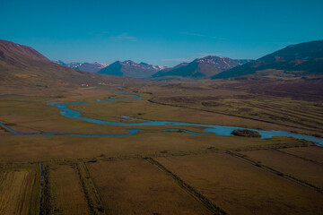 Beautiful valley of Miklavatn lake close to Haganes with aerial drone view of river delta and beautiful Icelandic hills and mountains in the background.