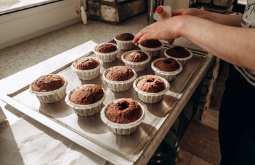 Chocolate muffins. Homemade chocolate muffins. The process of making homemade chocolate cupcakes with whipped cream.