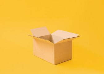 Opened cardboard box on bright yellow background. Opened cardboard box on bright yellow background