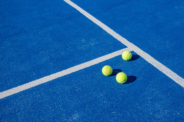 Selective focus. Three balls an the net of a paddle tennis court - obrazy, fototapety, plakaty