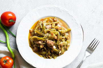 Green beans with meat and tomato dish in plate, traditional turkish cuisine