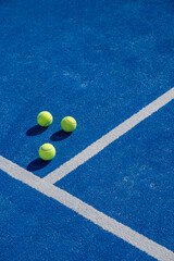 three balls on a paddle tennis court, selective focus,	