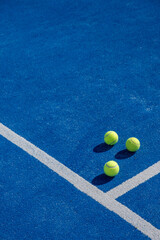 three balls on a paddle tennis court, selective focus,	
