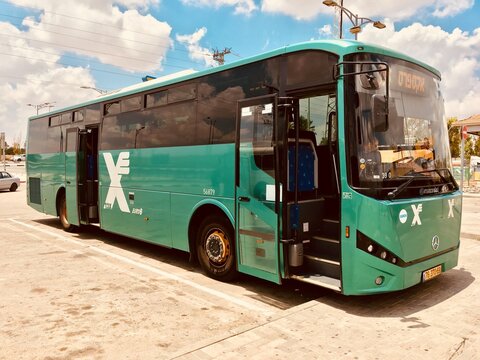 green passenger bus parked in Israel