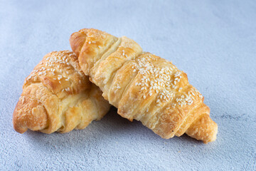 Gourmet cheese and sesame croissant, displayed on gray background
