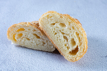 Gourmet cheese and sesame croissant, displayed on gray background