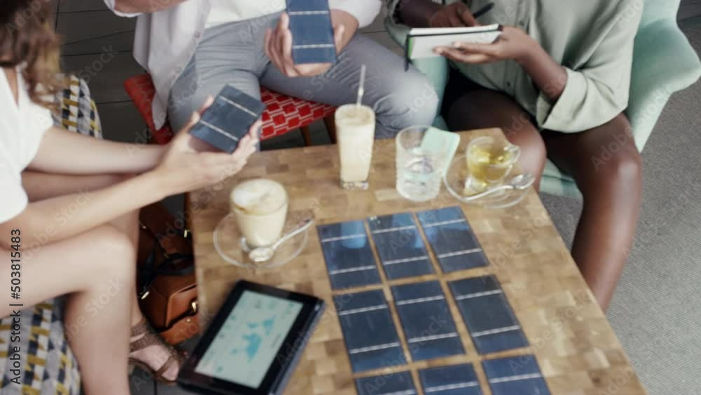 Poster diverse group of freelance engineers brainstorming and planning a solar panel product during a meeti
