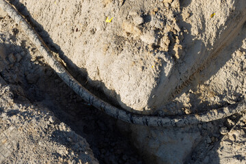 Excavation in the ground and old earth cable, telecommunications. Traces of corrosion on the cable....