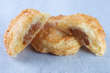 Puff pastry of arequipe, displayed on gray background