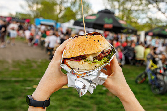 Eating burgers at an outdoor street food festival