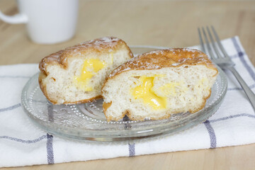 Deep-fried doughnut (paczki or sisky) with Lemon Custard Filling, Lemon Donut cut in half