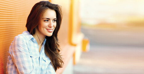 Summer portrait of beautiful young brunette woman in the city