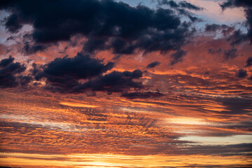 A sunrise paints the clouds every color of rainbow in plains of