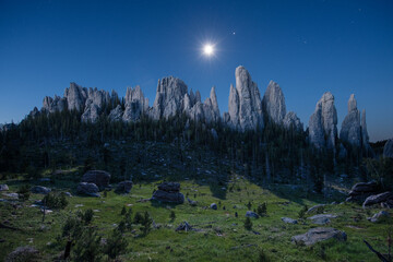 The moon sets as the massive spires of the Black Hills catch the