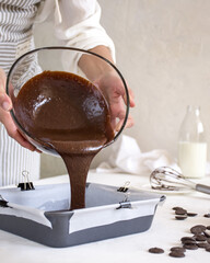 Gorgeous pour of brownie dough into mold