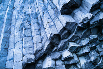 Basalt stones as a background. Reynisfjara Beach, Iceland. Sharp rocks. Photography for design. Textures in nature.