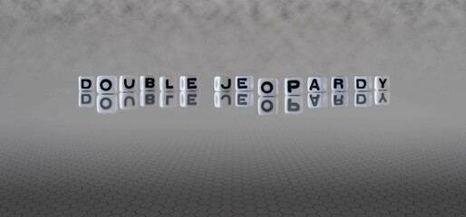 double jeopardy word or concept represented by black and white letter cubes on a grey horizon background stretching to infinity