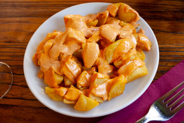 Typical Spanish potato dish Patatas bravas served with spicy sauce