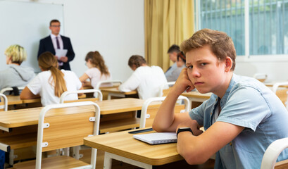 Fototapeta na wymiar Portrait of a tired student in school class