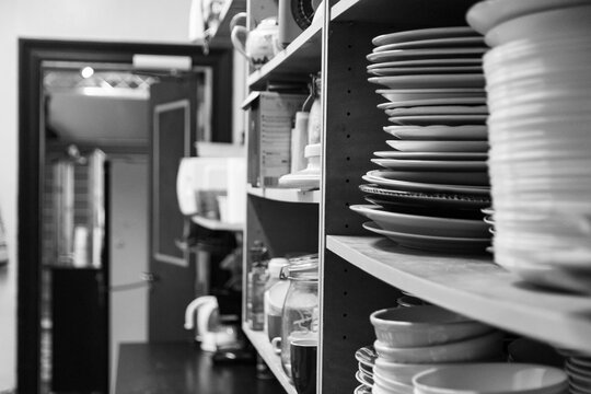 Clean dishes stacked in a kitchen service area
