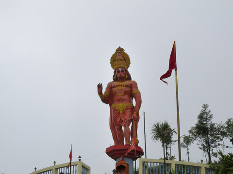 View of Haunman hindu god's statue in Kalimpong Sikkim temple with a flag and trees on background