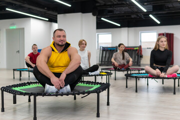 Women's and men's group on a sports trampoline, fitness training, healthy life - a concept...