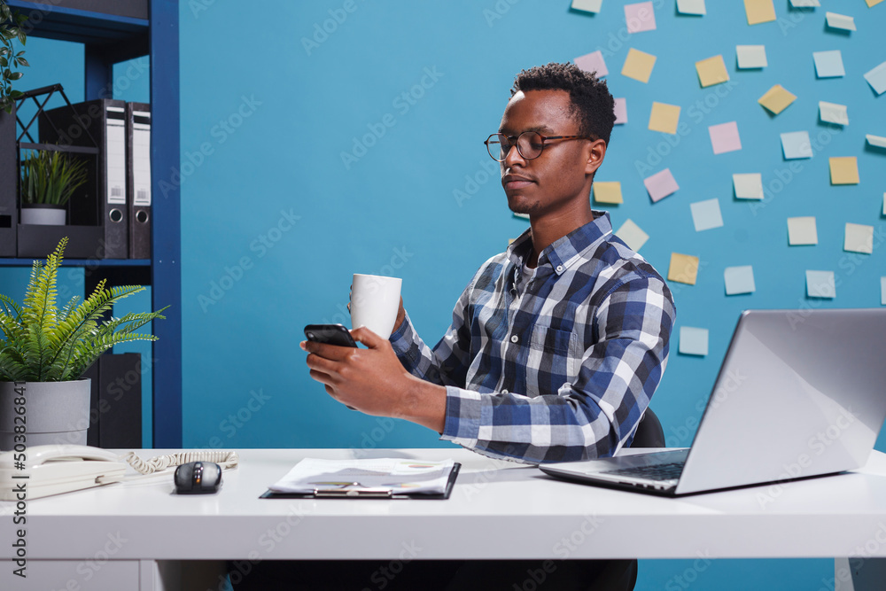 Poster marketing company businessman browsing social media on mobile smartphone while having a cup of coffe