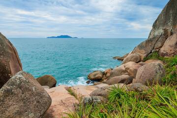 Fototapeta na wymiar Tropical coastline with plants, amazing rocks and blue ocean.