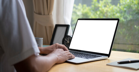 Close up view man working with computer tablet at home office..