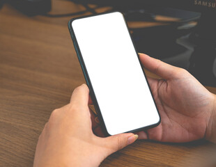 Close up business women using a smartphone with an empty white screen at the office workplace.