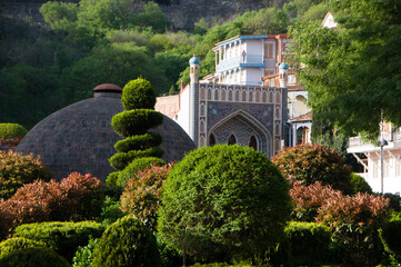 A very beautiful old oriental city surrounded by green plants. 

