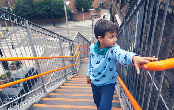 Little Boy Climbing Up The Stairs