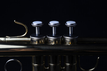 Closeup shot of a trumpet's parts on an isolated black background