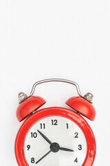 Classic red alarm clock with vertical whitespace