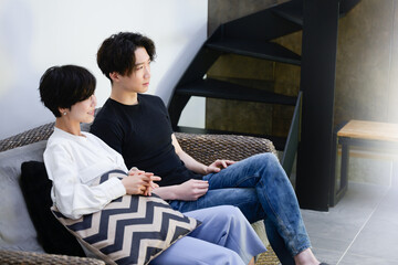 Couple relaxing in the living room watching a movie, etc.