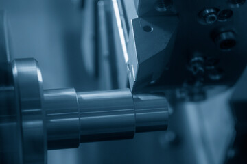 The  CNC lathe machine forming  cutting the metal shaft parts.