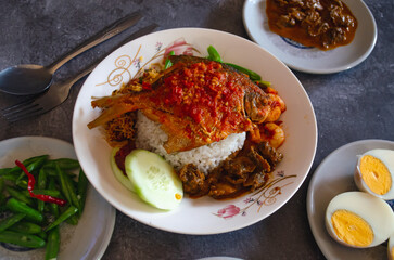 Tanjung Balai Rice Coconut Milk, topped with fish, vegetables and shellfish, at Medan, North Sumatera