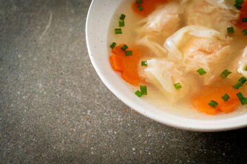 shrimp dumpling soup in white bowl