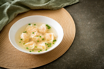 shrimp dumpling soup in white bowl