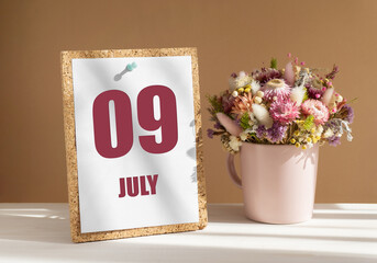 july 9. 9th day of month, calendar date.Bouquet of dead wood in pink mug on desktop.Cork board with calendar sheet on white-beige background. Concept of day of year, time planner, summer month