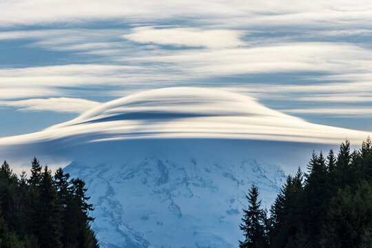 dramatic huge UFO shaped  lenticular cloud on top of Mt.Rainier in Washington.