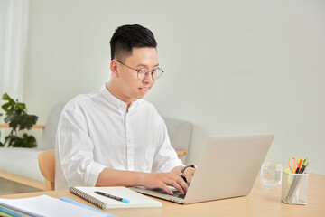A moment of young working with laptop at home in living room background 