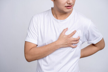 A person having a heart attack. Young asian man had chest pain and held his hand on his chest.