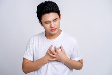 Handsome of asian man holding hands on chest suffering from heart attack, closeup
