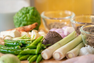Shrimp Paste Dip is a middle of chili padi, lemongrass, a background have a blurred bergamot and other Thai herbs.