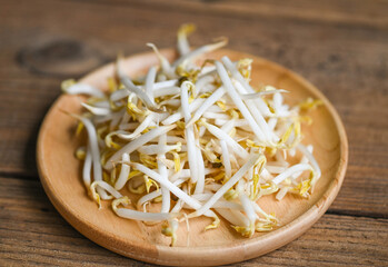 Bean sprouts on wooden plate table background in the kitchen, Raw white organic bean sprouts or...