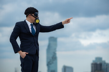 portrait of businessman wearing gas pollution protection face mask and suit, concept of danger...