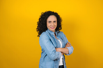 hispanic adult woman portrait on yellow background in Mexico Latin America