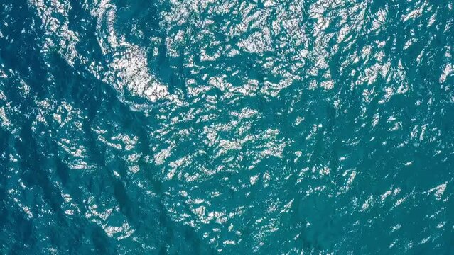 Aerial footage of blue ocean and sparkling water. high angle view. clean water ripple scene. Beautiful natural scenery in Sayram lake, Xinjiang, China.